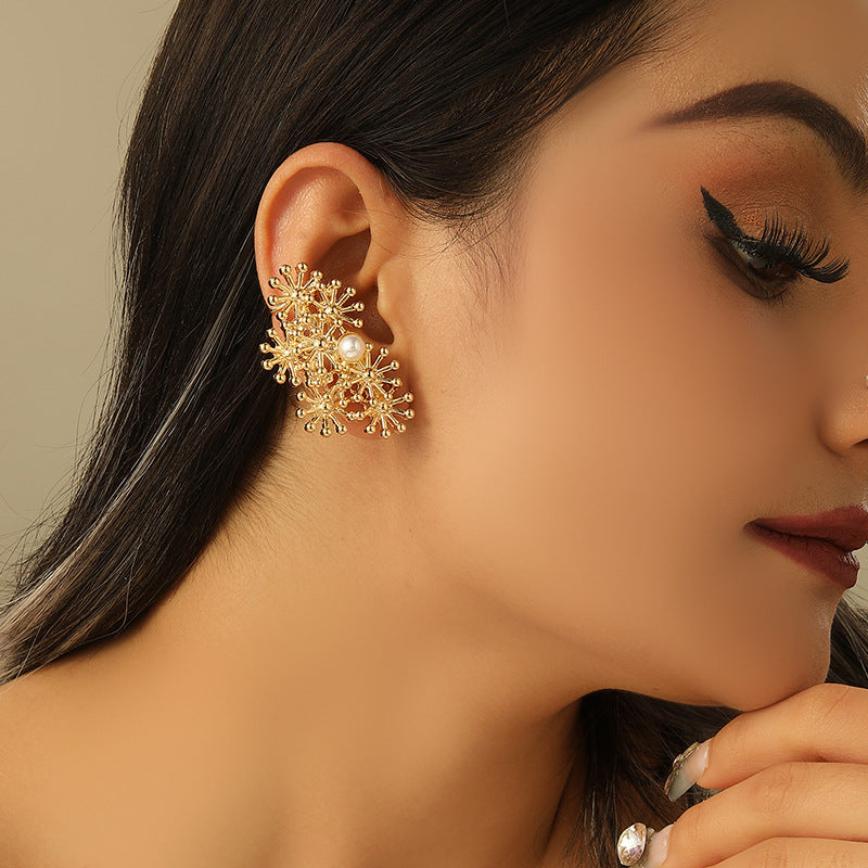 Women’s ear clips with elaborate flower design and pearl accent Tom Cottons