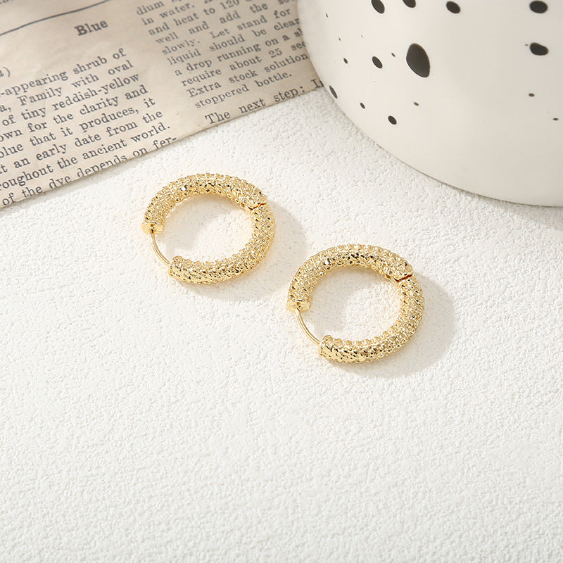 Women's hoop earrings with modern, textured design Tom Cottons