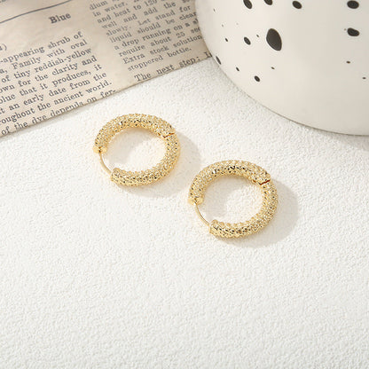 Women's hoop earrings with modern, textured design Tom Cottons