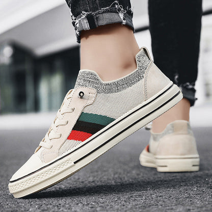 Ladies' sneakers with breathable mesh structure and trendy striped elements