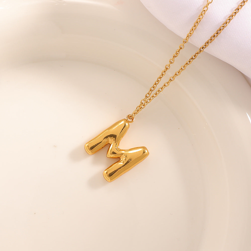 Women's necklace with curved letter pendant Tom Cottons