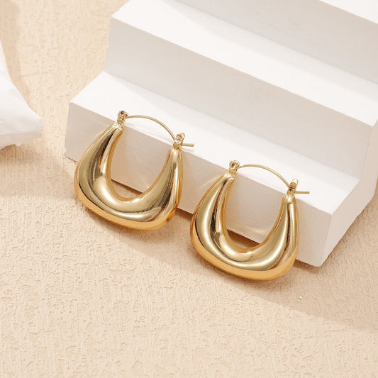 Ladies earrings in a modern, curved design Tom Cottons