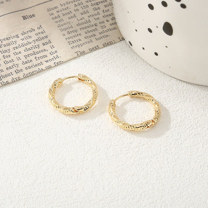 Women's hoop earrings with modern, textured design Tom Cottons