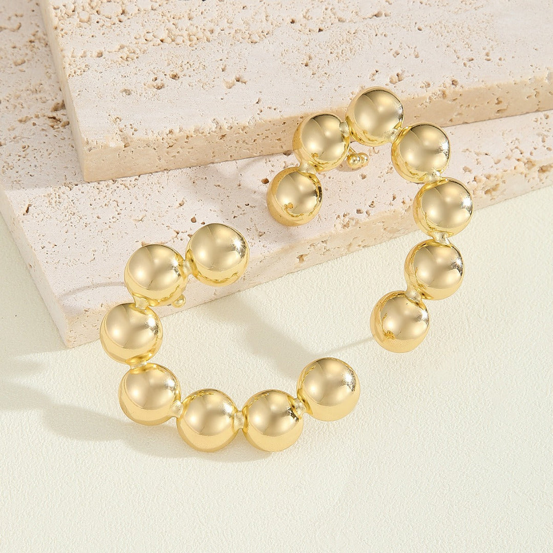 Women's bracelet with structured, golden beads Tom Cottons