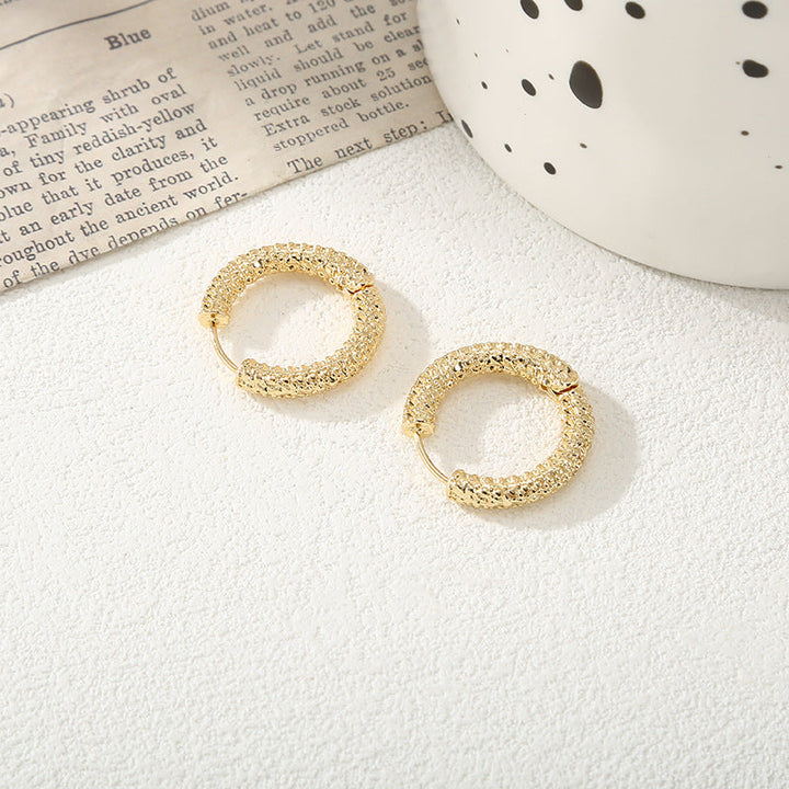 Women's hoop earrings with modern, textured design Tom Cottons
