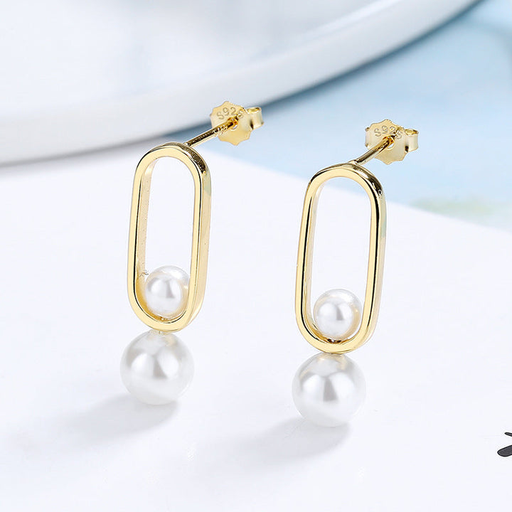 Women's stud earrings with modern oval design and elegant pearls Tom Cottons