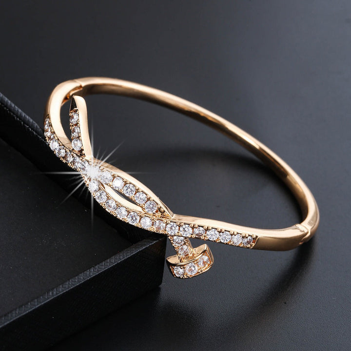 Women's bangle with elegant infinity pattern and sparkling zirconia Tom Cottons