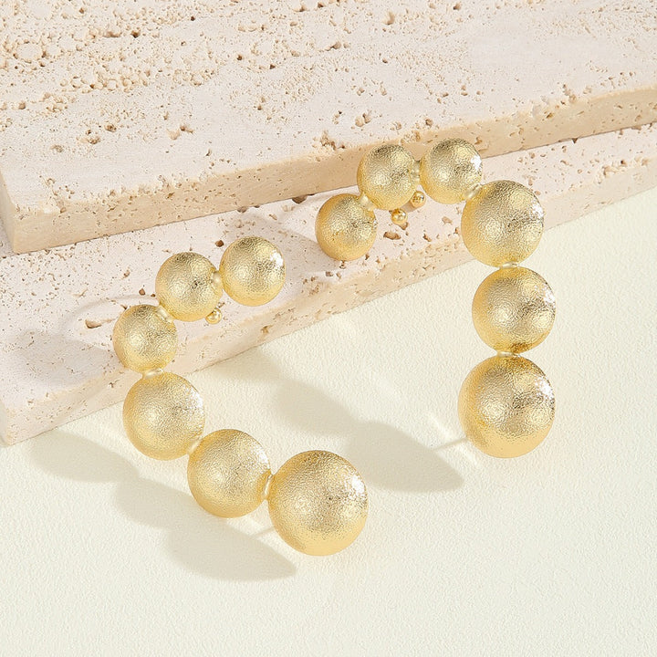 Women's bracelet with structured, golden beads Tom Cottons