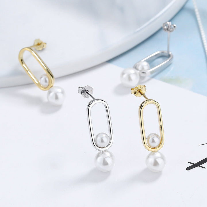 Women's stud earrings with modern oval design and elegant pearls Tom Cottons