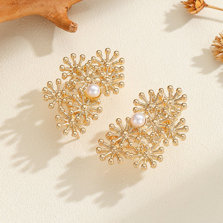 Women’s ear clips with elaborate flower design and pearl accent Tom Cottons